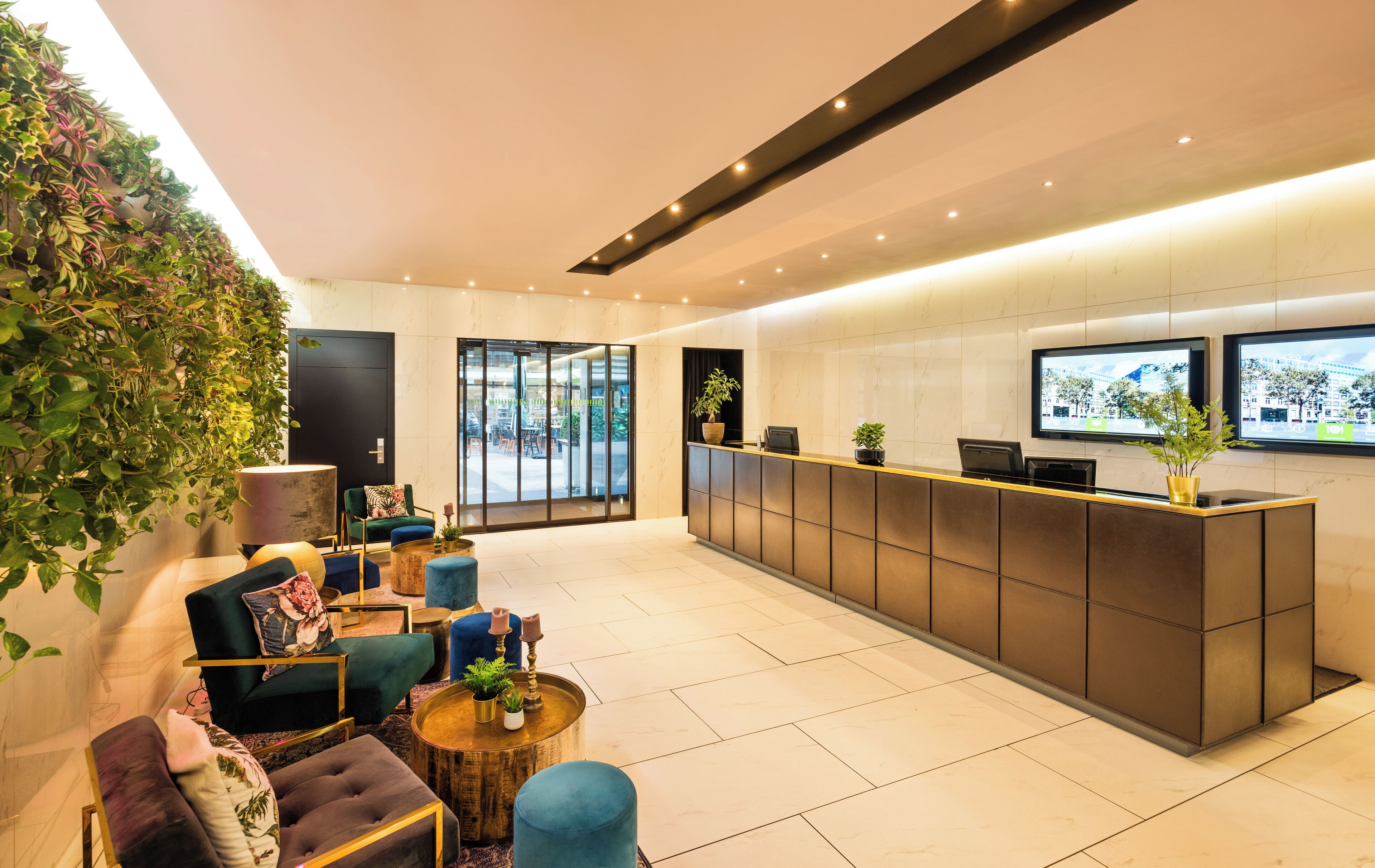 A modern reception area with a reception desk, seating area, and large windows.