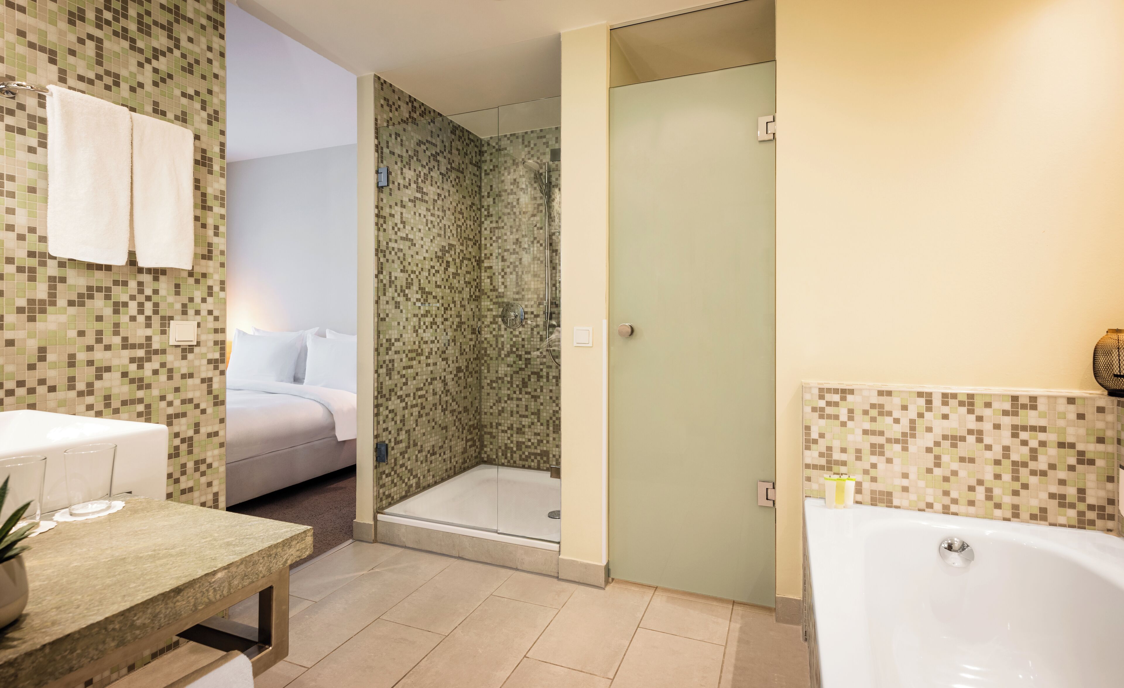 deluxe room, 1 king bed (kudamm view) | bathroom | shower, eco-friendly toiletries, hair dryer, towels