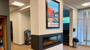 Een modern interieur met een open haard, een geldautomaat en een plank met snacks.