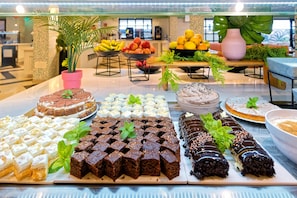 A buffet with various desserts including cakes, brownies, and pastries. - Servatur Isora Suites (Guia de Isora)