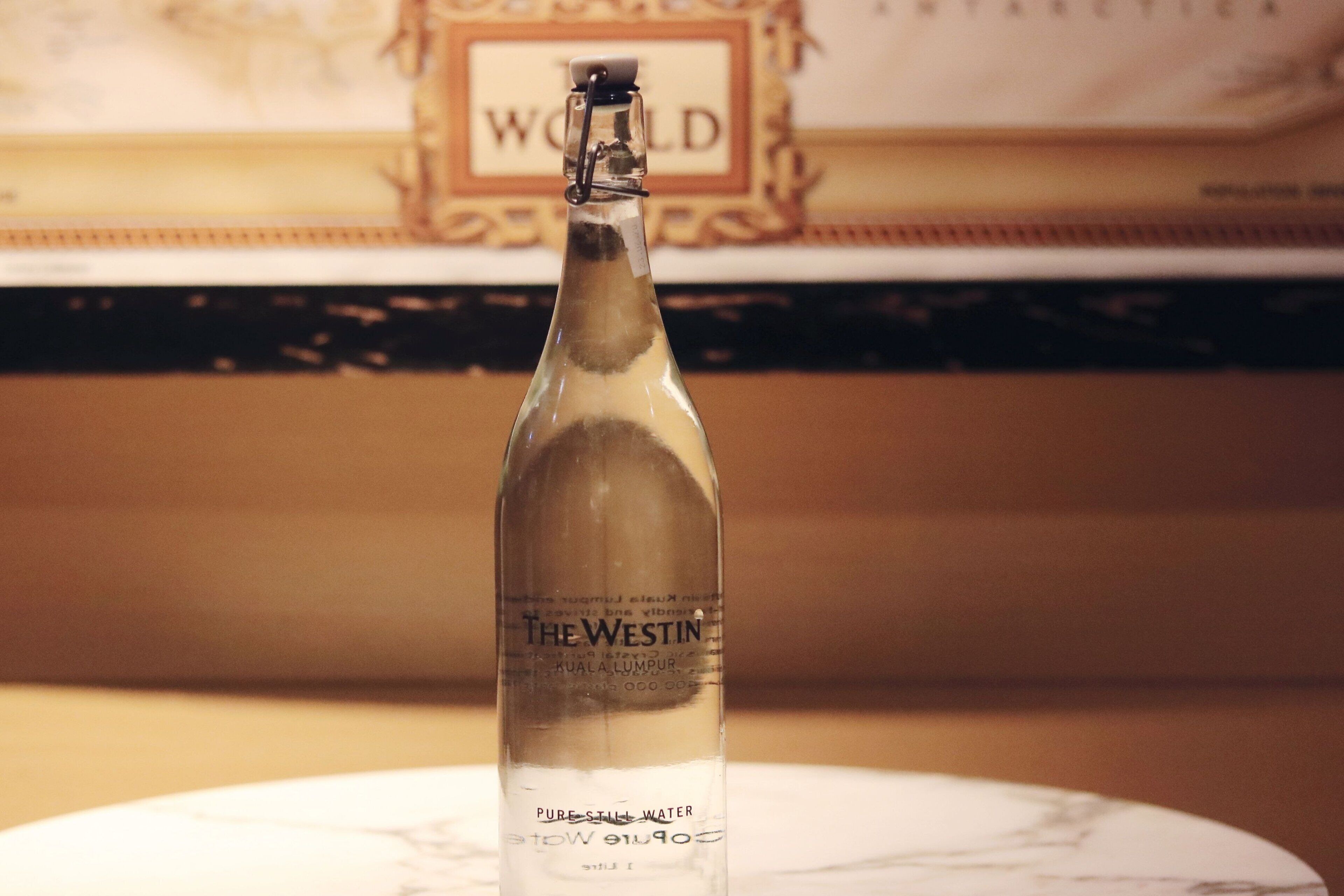 A bottle of The Westin water on a marble surface.
