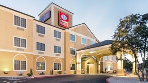 A Comfort Suites hotel with a central entrance, multiple windows, and a parking lot. - Comfort Suites Odessa near University (Odessa)
