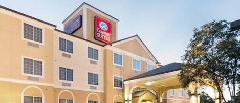 A Comfort Suites hotel with a central entrance, multiple windows, and a parking lot.