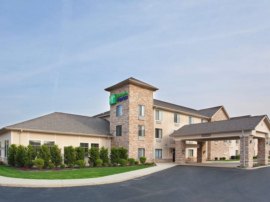 A Holiday Inn Express hotel with a brick tower, multiple windows, and a covered parking area.