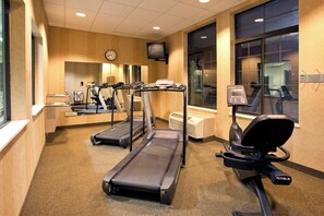 A hotel fitness center with treadmills, an elliptical, and a stationary bike.