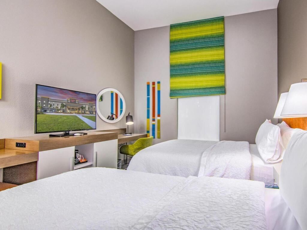 Premium bedding, desk, laptop workspace, blackout drapes