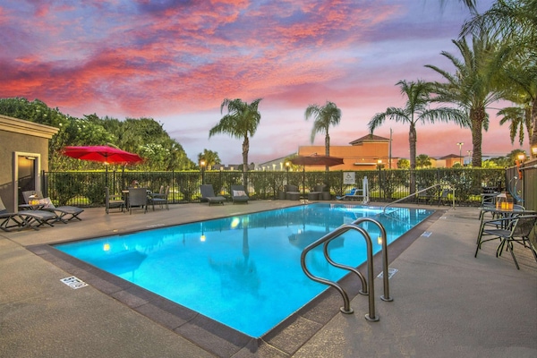 Outdoor pool, open 9:00 AM to 10:00 PM, pool loungers