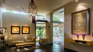 A modern lobby with a sofa, coffee table, and artwork on the walls.
