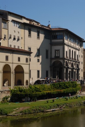 Stunning historic building with arched doorways and a balcony overlooking the water.