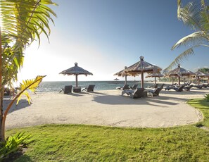 On the beach, white sand, sun loungers, beach massages