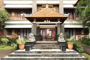 Traditional architecture meets elegant entrance, featuring a central pavilion and stone steps.