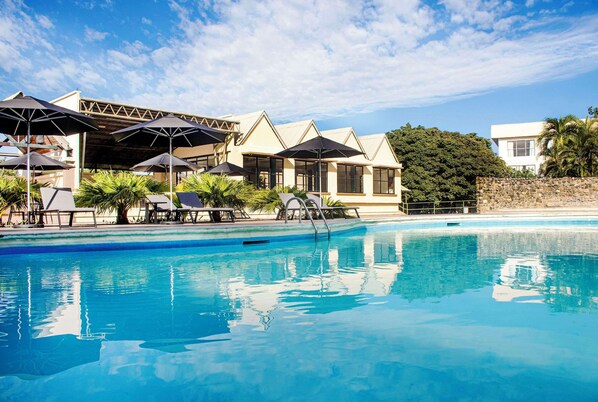 Outdoor pool, open 10:00 AM to 7:00 PM, pool umbrellas, pool loungers