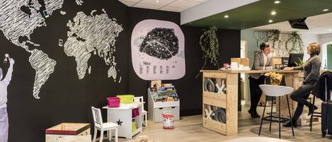 A modern interior with a world map mural, a bar area, and a seating space.
