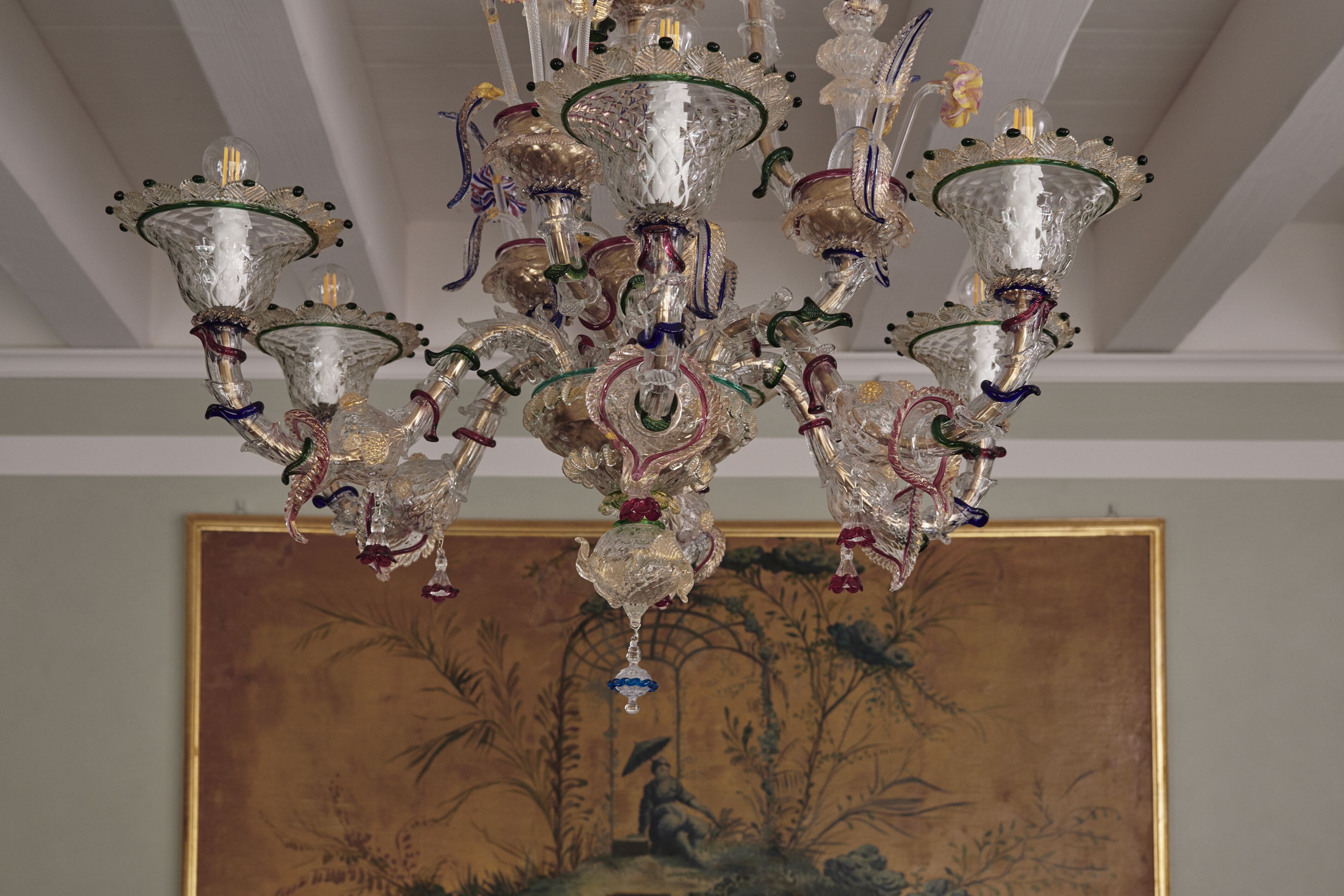 A chandelier with multiple glass shades and intricate metalwork.