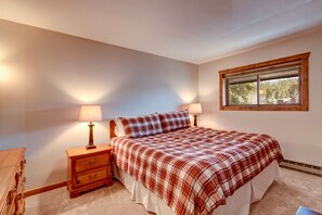 Cozy retreat with a neatly made bed, nightstand, and dresser, plus a window for natural light.