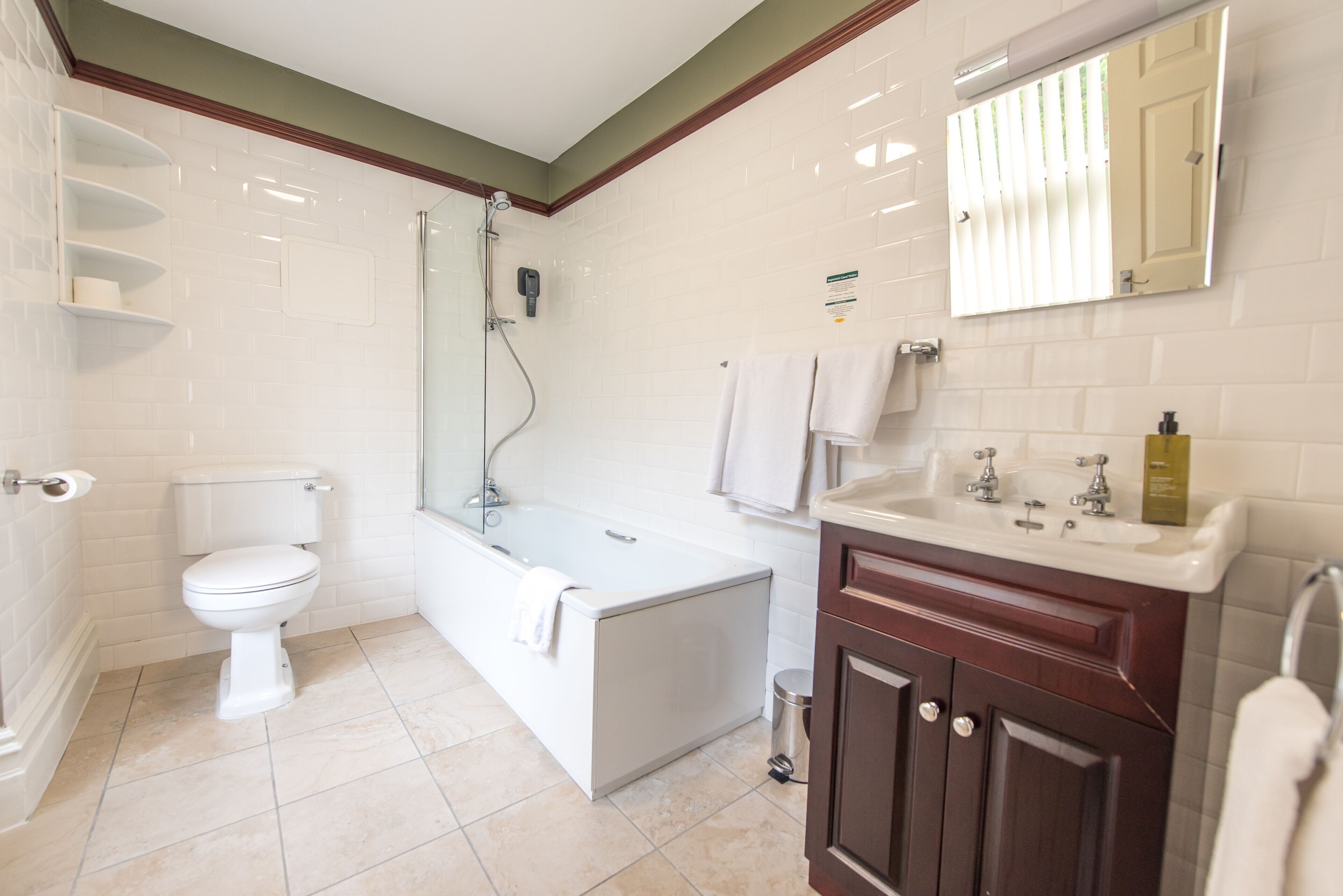 A bathroom with a toilet, bathtub, and sink.