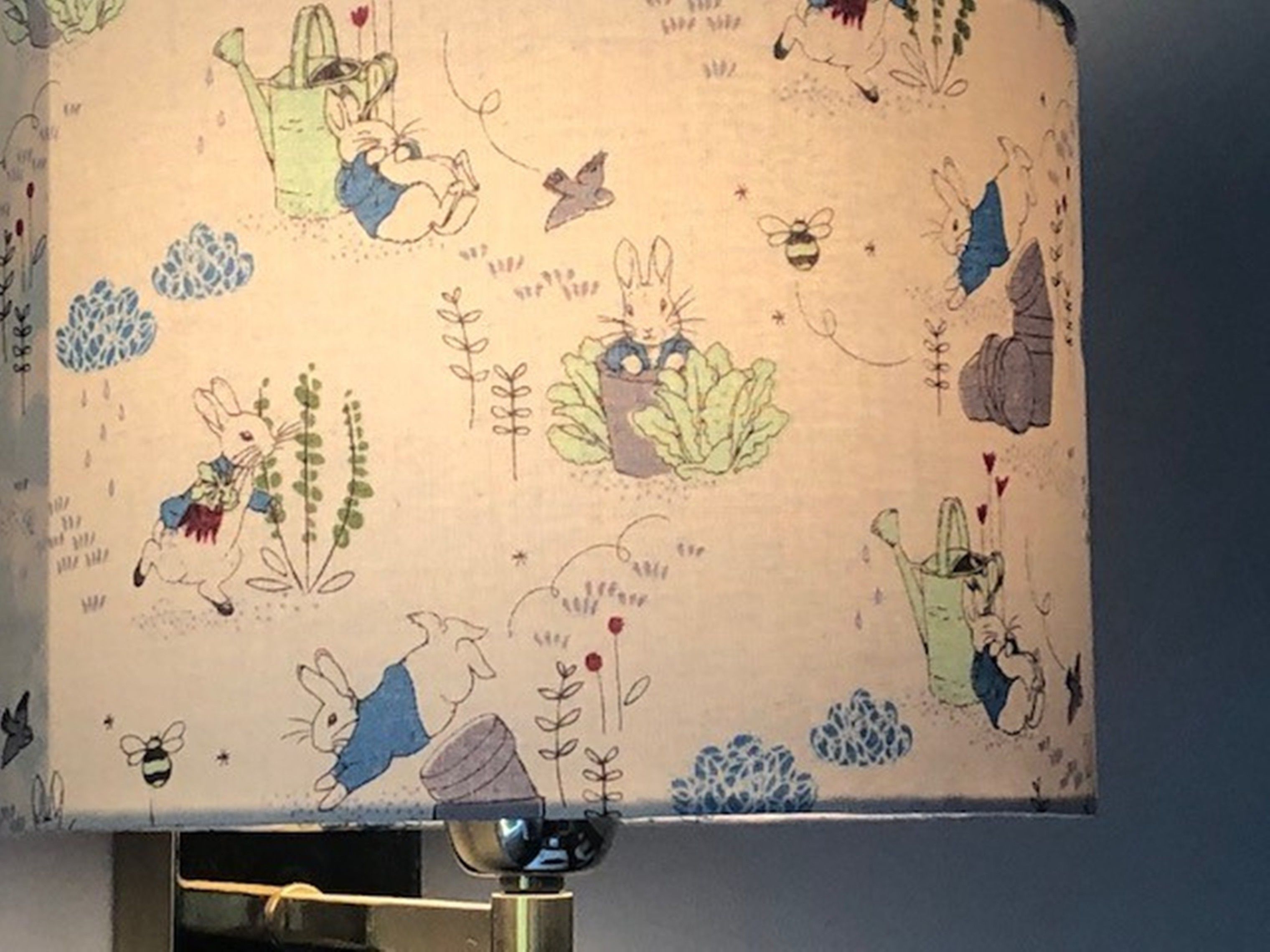 A wall with a pattern of cartoon rabbits and plants.