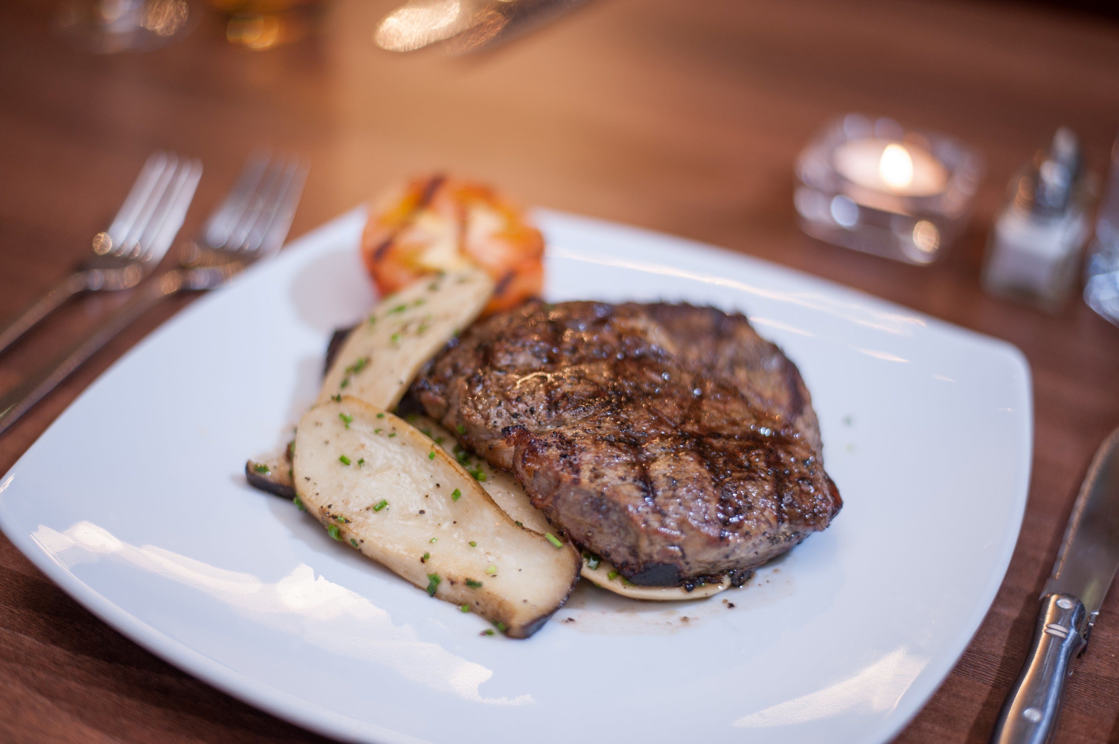 A plate with a steak and potatoes.