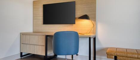 A modern office space with a desk, chair, and bench.