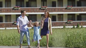 A family walking on a path with a building in the background.