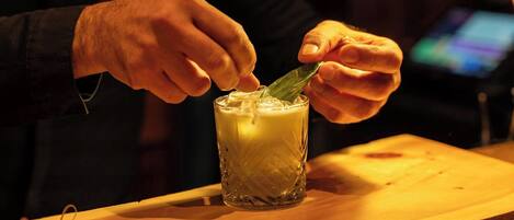 A person stirring a drink in a textured glass.