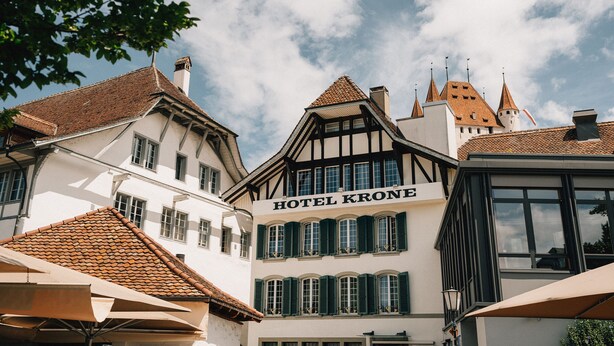 A traditional European building with a sign reading "HOTEL KRONE."