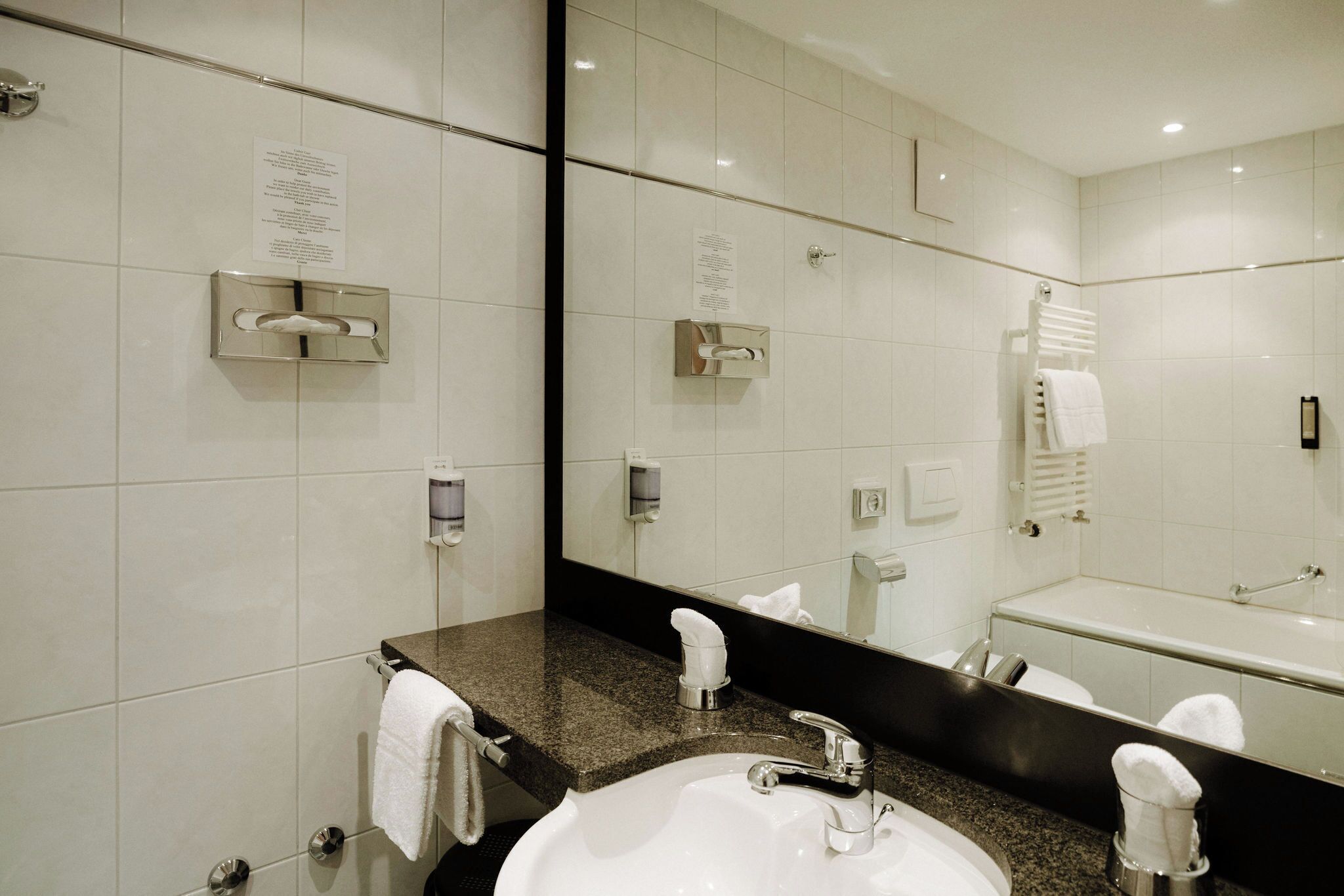 deluxe double room, mountain view (matterhorn) | bathroom | combined shower/bathtub, hair dryer, slippers, towels