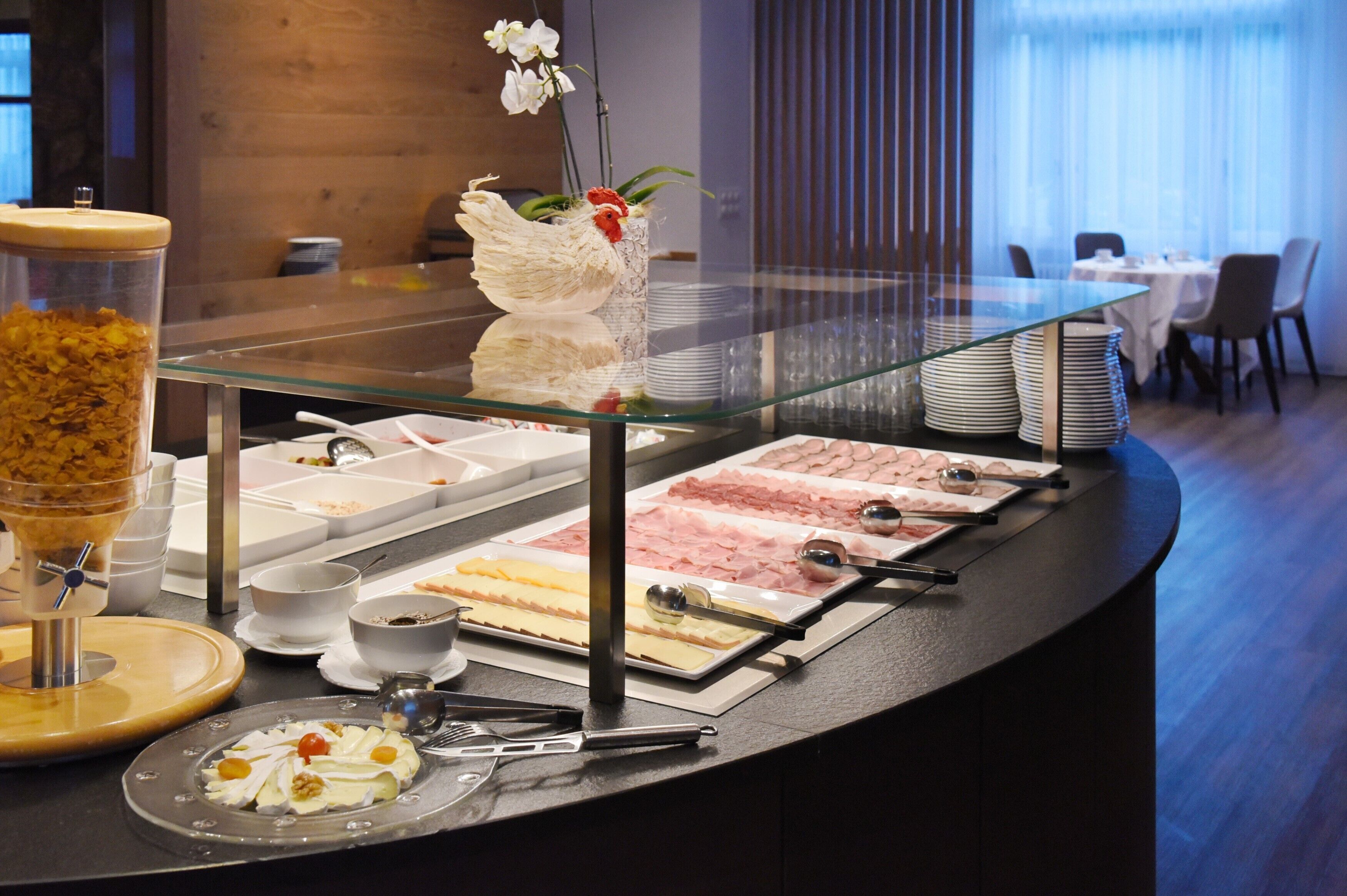 A buffet setup with various food items and utensils.