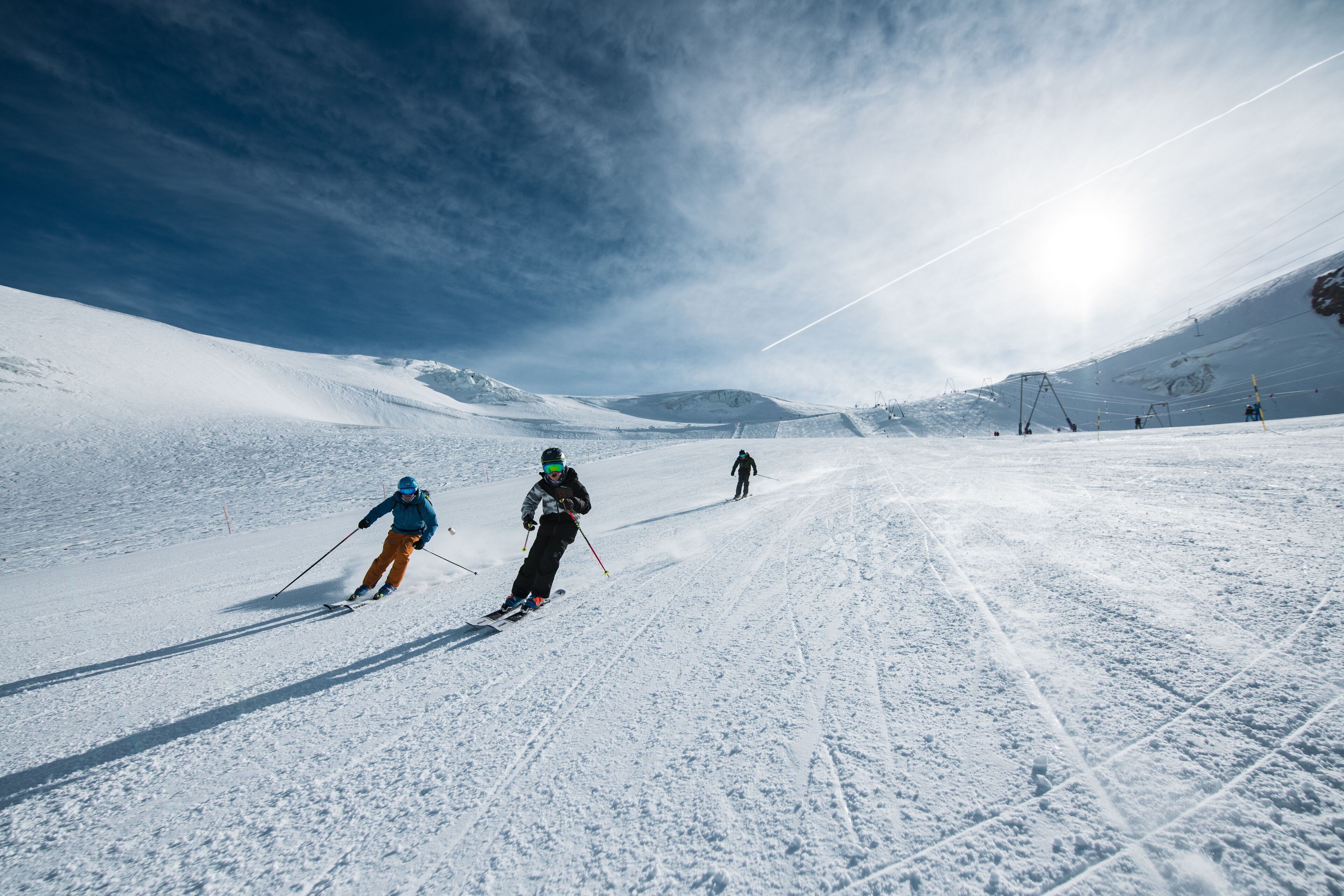 A snowy ski slope with skiers.
