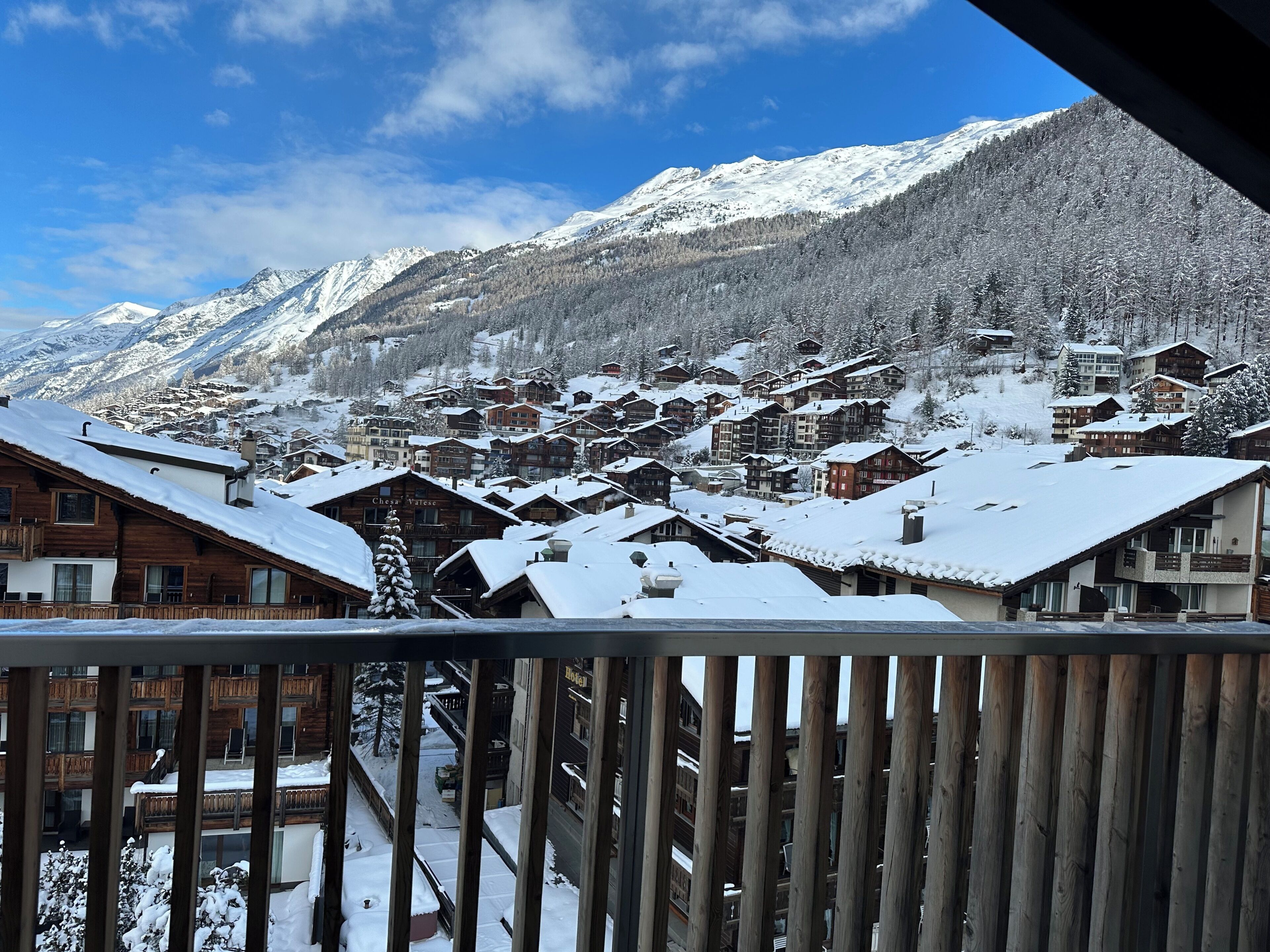 A snow-covered mountain town with wooden buildings and a clear sky.