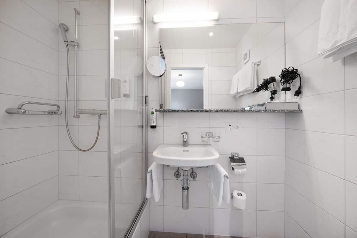 cozy double room | bathroom | hair dryer, towels