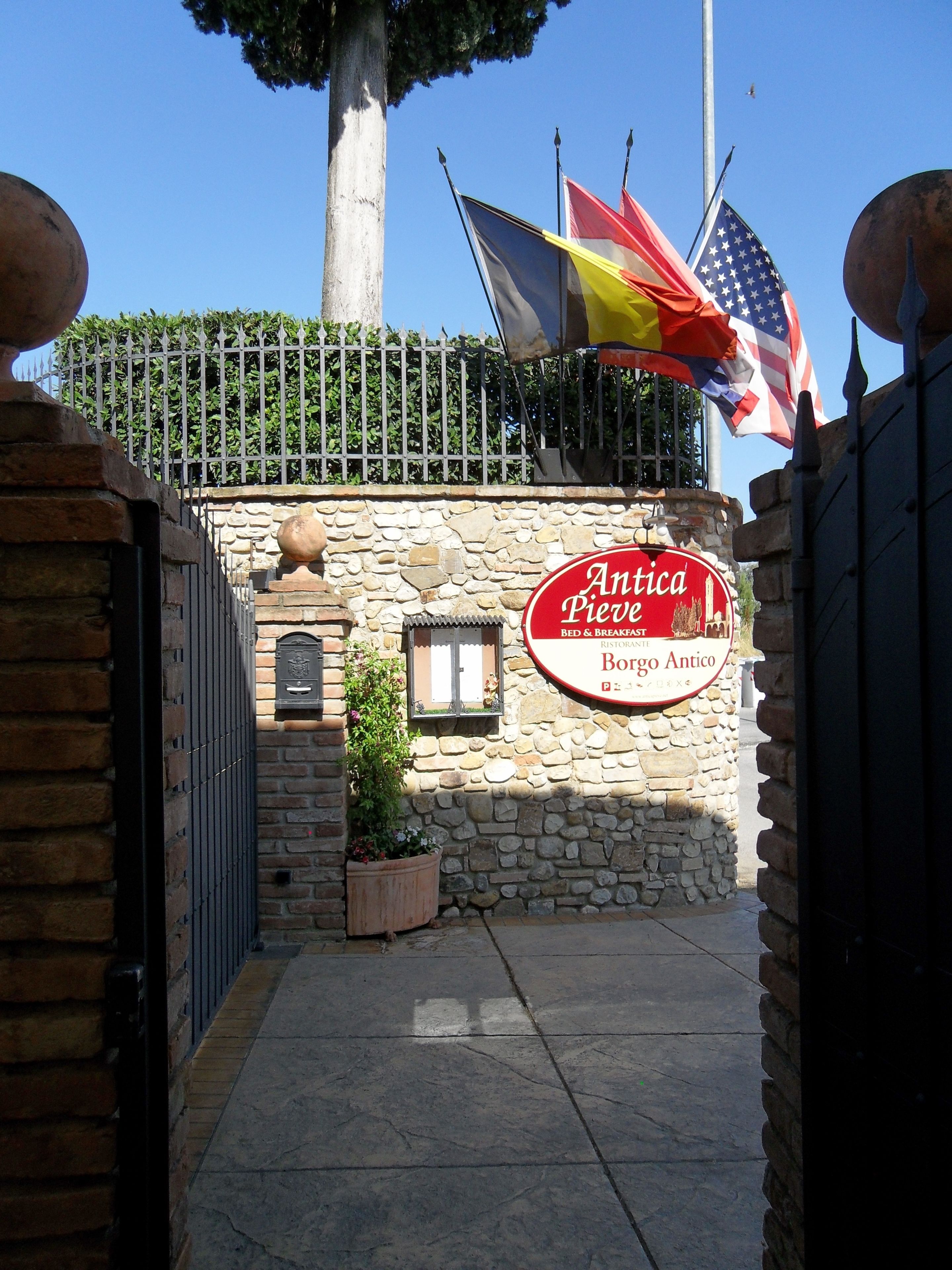 A stone building with a sign for 'Antica Pieve Bed & Breakfast' and 'Borgo Antico'.
