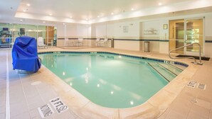 An indoor swimming pool with clear lane markings, a covered seating area, and a reception desk. - Fairfield Inn & Suites by Marriott Columbus (Columbus)