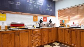 A kitchen with wooden cabinets, a chalkboard with baking instructions, and various kitchen appliances.