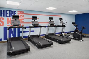 A fitness center with treadmills, a stationary bike, and a wall with motivational text. - Hampton Inn by Hilton Odessa (Odessa)
