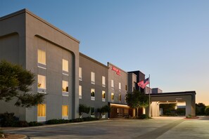 A modern hotel building with a flat facade, multiple windows, and a welcoming entrance. - Hampton Inn by Hilton Odessa (Odessa)