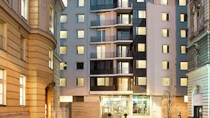 A hotel with a modern facade, multiple balconies, and a clear entrance. - NH Budapest City (Budapest)