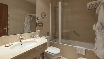 A modern bathroom with a sink, toilet, and glass-enclosed shower.