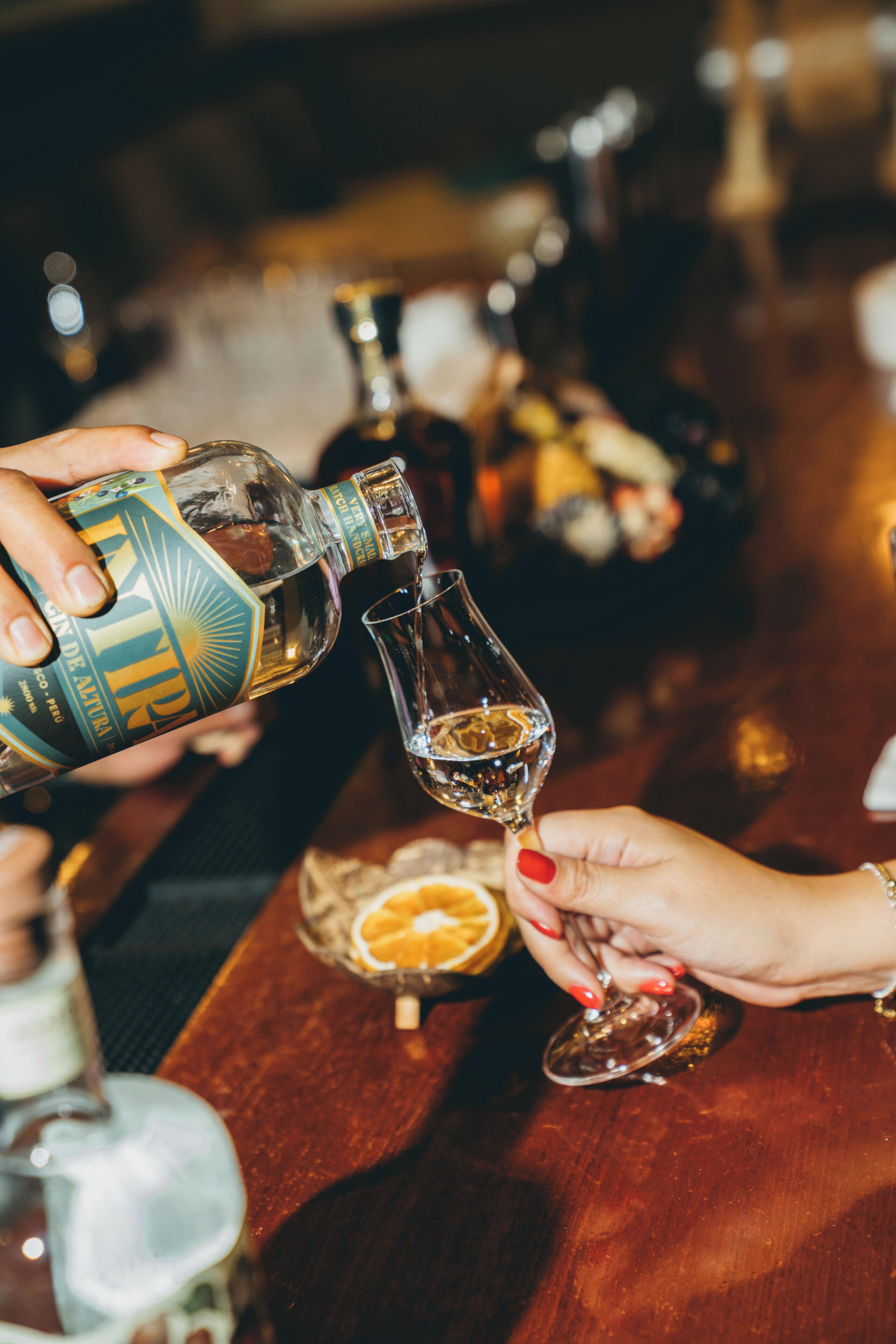 A person pouring a drink into a glass.