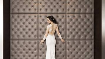 Guests can stand in front of the elegant wall panel, featuring a symmetrical diamond-patterned design.