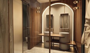 A modern bathroom with a vanity, a mirror, and a toilet. - Grand Hotel Bristol (Stresa)