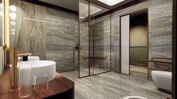 A modern bathroom with marble walls, a glass shower enclosure, and a wooden vanity with a white sink.