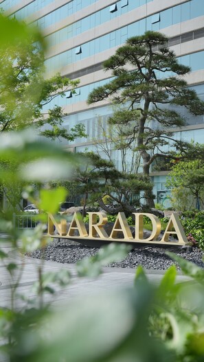 A building with a modern facade and a large tree in front. - Narada Grand Hotel Hangzhou Westlake (Hangzhou)