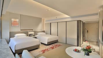 Relax in this serene space with a large bed, two bedside tables, and a small table for your essentials.