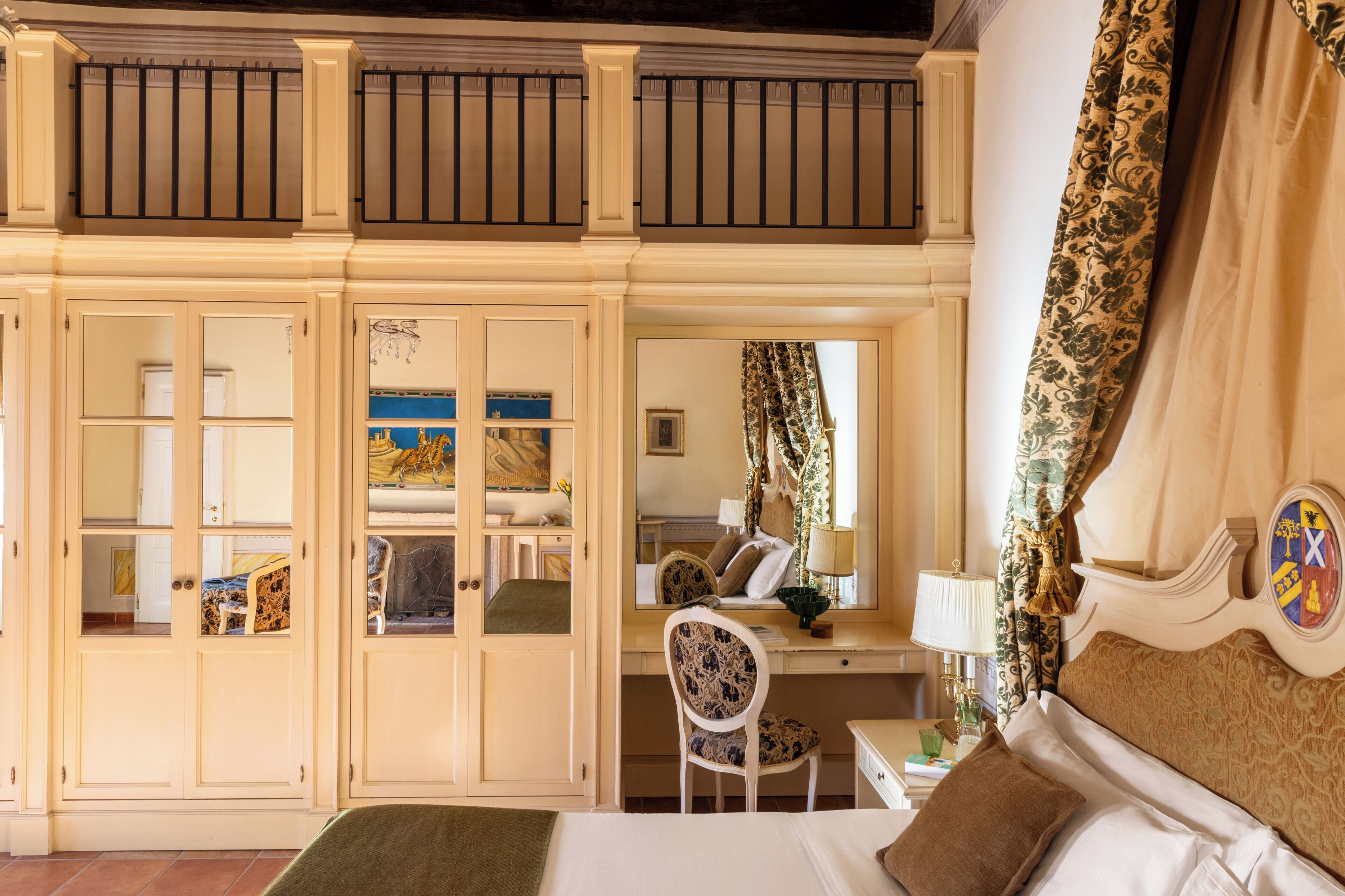 A bedroom with a bed, a desk, a chair, and a wardrobe.