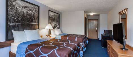 A hotel room with two beds, a TV, a dresser, and a large framed picture on the wall.