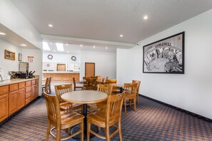 Enjoy meals in the dining area with a round table and matching chairs.