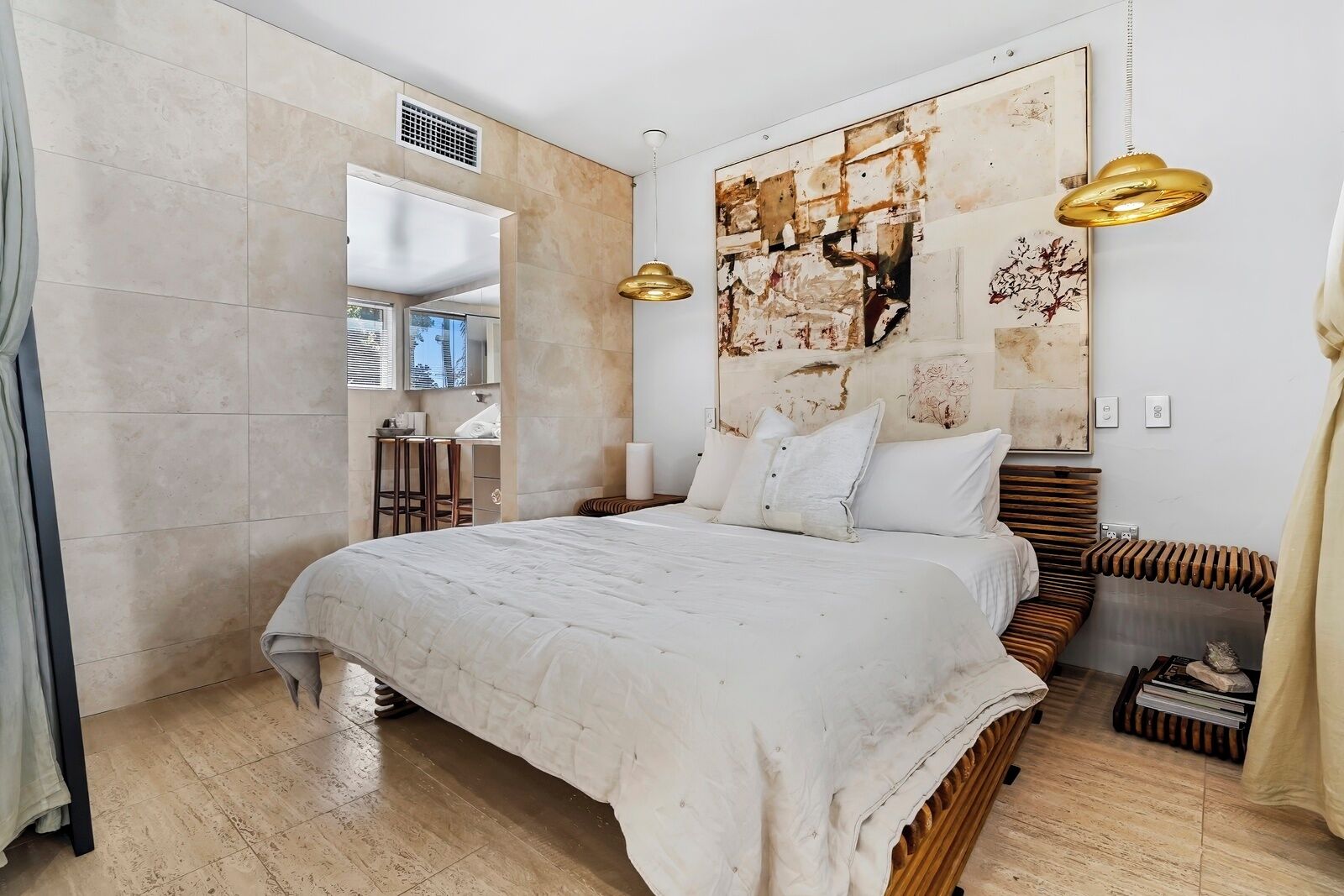 A modern bedroom with a large bed, a wooden headboard, and a unique abstract painting on the wall.