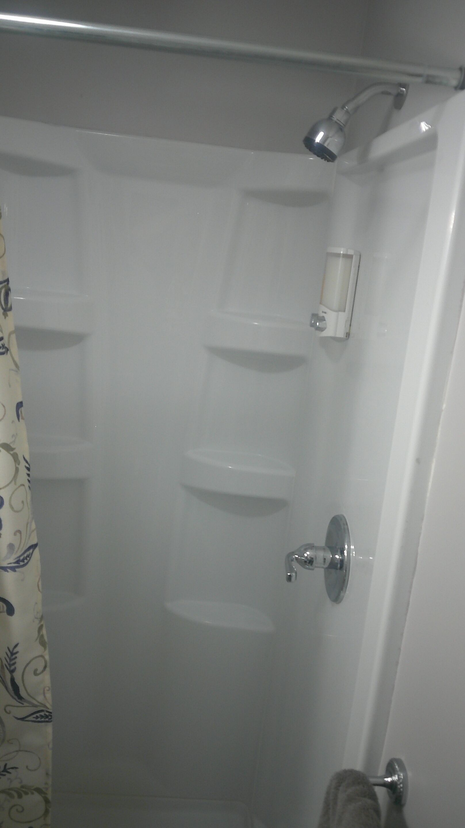 A bathroom with a shower, a toilet, and a sink.