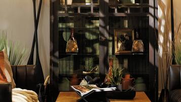 A cozy living room with a wooden coffee table, leather sofas, and a decorative wall sign.